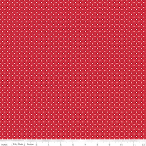 Könnte beinhalten: Roter Stoff mit weißen Polka-Dots. Das Material zeigt ein sich wiederholendes Muster aus kleinen, gleichmäßig verteilten weißen Punkten auf rotem Hintergrund. Ein Lineal am unteren Rand zeigt die Maße in Zoll an.
