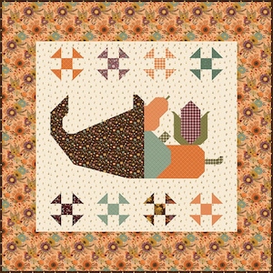 Könnte beinhalten: Ein Patchwork-Quilt mit Erntethema. Das zentrale Design zeigt ein Füllhorn mit Kürbis und Mais. Der Quilt hat einen floralen Rand in Orange-, Braun- und Cremetönen. Die Abmessungen des Quilts sind nicht sichtbar.