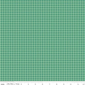 May include: Green and white plaid fabric with a small-scale pattern. The fabric features a grid-like design with intersecting lines, creating a checkered effect. The pattern repeats across the surface, with a ruler along the bottom edge.