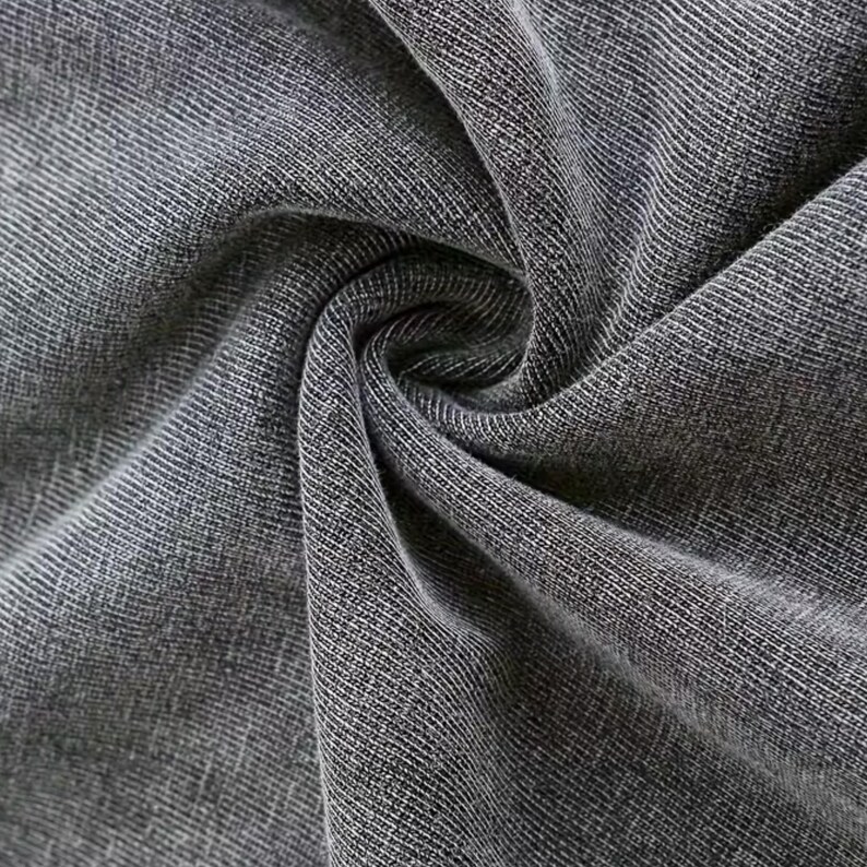 a close-up view of a wrinkled gray fabric, possibly denim or a similar type of material.