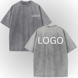 two gray t-shirts with the word "LOGO" printed on the back.