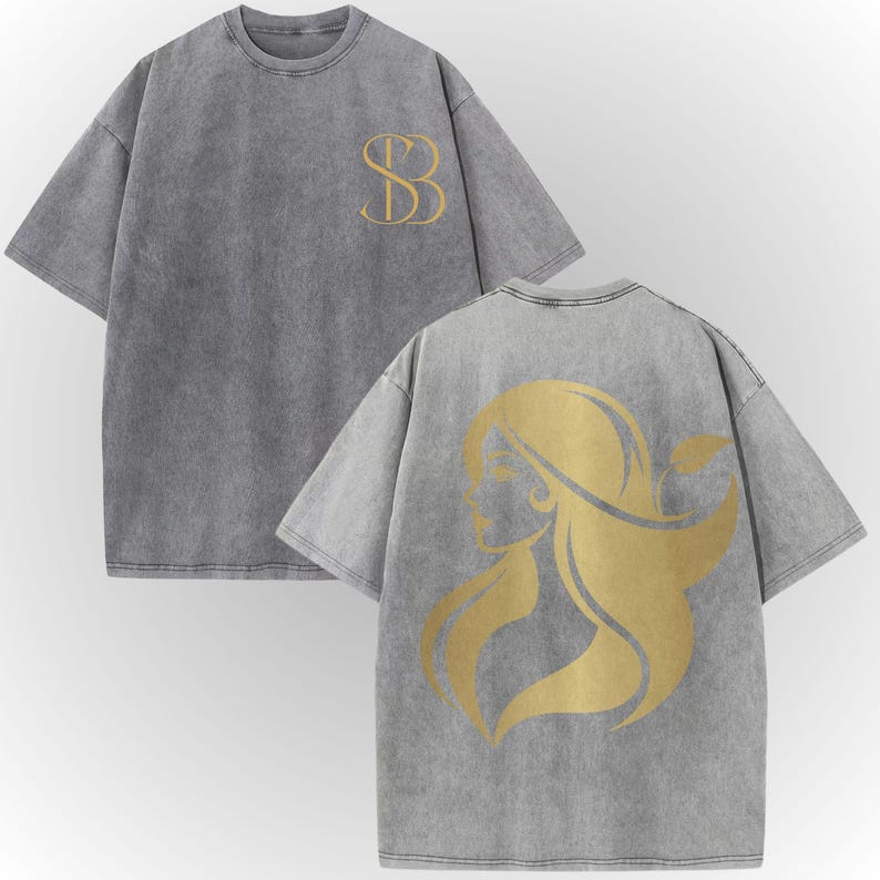 a gray t-shirt with a gold graphic design on the back.
