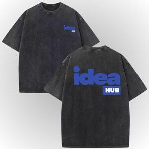 a black t-shirt with the word "IDEA" and "HUB" printed on it in blue text.