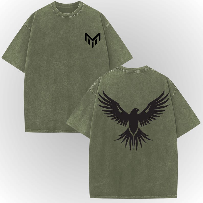 a green t-shirt with a graphic design on the back, featuring a stylized bird or eagle with outstretched wings.