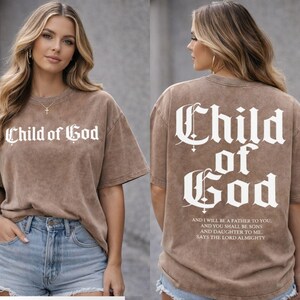 a woman wearing a brown t-shirt with the text "Child of God" printed on it.