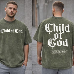 A man wearing a green t-shirt with the text "Child of God" printed on it, standing in front of a gray wall.