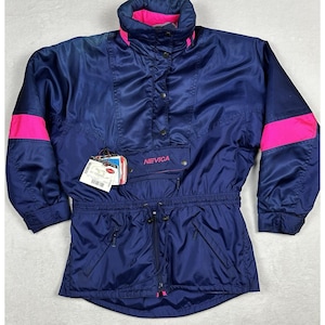 May include: A navy blue vintage ski jacket with bright pink accents on the sleeves and collar. The jacket features a high collar, a front pocket, and the brand name "NEVICA" is visible. It has a drawstring waist and a zipper closure.