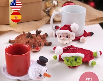 May include: Crocheted Christmas-themed coasters featuring a reindeer, Santa Claus, a snowman, and the Grinch. The coasters are in brown, red, white, and green. A red mug and a white mug are also present.