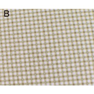 May include: A close-up of a fabric with a repeating pattern of small hearts within a grid of light green and brown squares. The letter "B" is in the upper left corner. The fabric has a soft, textured appearance.