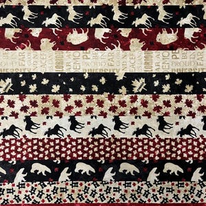 May include: A fabric with alternating horizontal stripes featuring Canadian symbols. The stripes display maple leaves, moose, bears, and text that reads "Glorious and Free" and "Proud". Colors include red, black, white, and beige.