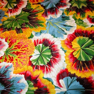 May include: A colorful fabric with a repeating pattern of stylized flowers. The flowers are a mix of red, yellow, white, and green.