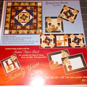 May include: A pattern sheet for a quilt featuring a squirrel and chipmunk design. The sheet includes two large pattern sheets, measuring 20 inches by 28 inches, and the text "Companion Blocks Squirrely" and "#5156".
