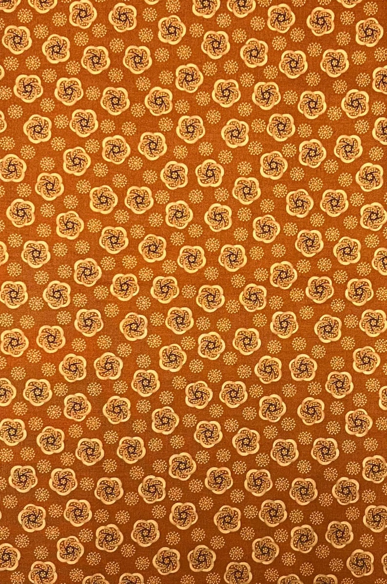 May include: A repeating pattern of stylized floral and dot designs on a brown background. The flowers are cream-colored with dark brown centers, and the dots are a lighter shade of brown. This fabric design is suitable for various craft projects.