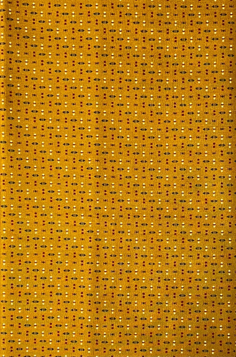 May include: Mustard yellow fabric with a repeating pattern of small white, red, and black shapes. The design includes small triangles and dots, creating a textured appearance. This textile is suitable for various sewing projects.