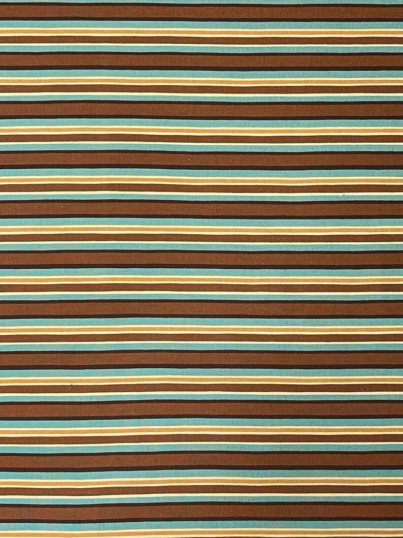 May include: A close-up of a fabric with horizontal stripes. The stripes alternate between brown, light blue, tan, and white. The pattern is evenly spaced and creates a textured appearance.