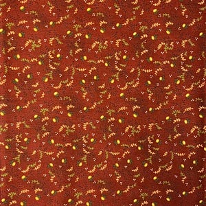 May include: A fabric with a repeating pattern of yellow lemons, green leaves, and small white dots on a dark red background. The design is evenly spaced across the fabric, creating a consistent and detailed pattern.