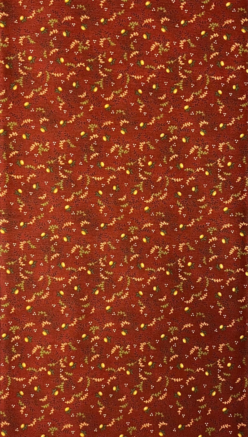 May include: A fabric with a repeating pattern of yellow lemons, green leaves, and small white dots on a dark red background. The design is evenly spaced across the fabric, creating a consistent and detailed pattern.