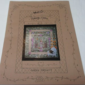 May include: A brown paper pattern for a quilt titled "Garden Serenity" with a drawing of a quilt featuring a floral design and the text "Rabbits Haven".