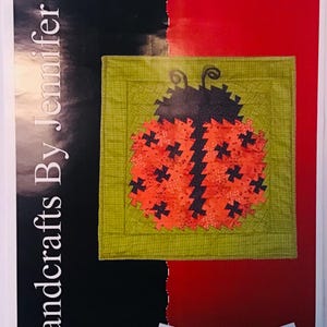 May include: A quilt pattern featuring a ladybug design with black and red fabric. The pattern is titled "Ladybug Twist" and is by Handcrafts By Jennifer.