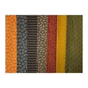 May include: A collection of fabric swatches in various colors and patterns. The swatches include floral, geometric, and abstract designs in shades of orange, navy, black, gold, red, yellow, and green. The fabrics are arranged vertically.