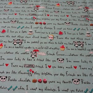 May include: A light blue fabric with a repeating pattern of panda bears, cupcakes, and other cute illustrations. The fabric features the text "Friends Forever...whatever the weather" and "I'm soooo lucky to have a friend like you".