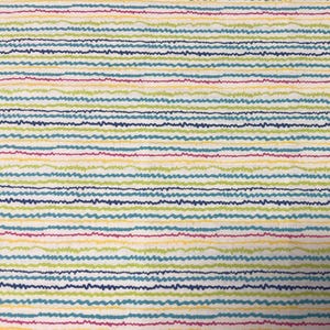 May include: A fabric with a white background and horizontal wavy stripes in various colors, including blue, green, yellow, and pink. The stripes have a hand-drawn appearance, creating a textured look. The overall design is simple and colorful.
