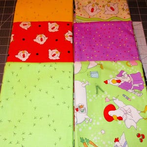 May include: Five different fabric swatches featuring various chicken-themed patterns. The swatches are arranged in a vertical stack. The top swatch is yellow, the second is red with white chickens, the third is purple with white dots, the fourth is green with white chicken footprints, and the bottom swatch is green with white chickens and other details.