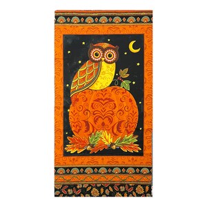 May include: A rectangular fabric panel depicting an owl on a pumpkin. The owl has large eyes and is set against a black background with stars and a crescent moon. The panel has an orange border with floral patterns. The pumpkin is orange.