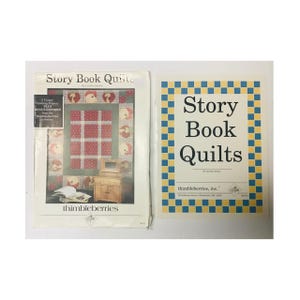 May include: Two quilting pattern books with a yellow and blue checkered cover. The cover of the book on the left shows a quilt with a red and white checkered pattern and a heart design. The book on the right has the title "Story Book Quilts" printed on the cover. Both books are published by Thimbleberries, Inc.