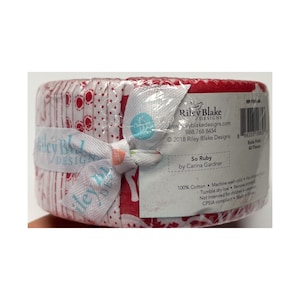 May include: A bundle of fabric strips, wrapped and tied with a ribbon. The fabric is red and white with various patterns. The packaging includes the text "So Ruby" and "Riley Blake Designs".