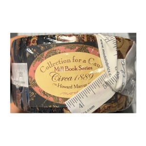 May include: A fabric bundle with a paisley design in black, brown, and gold, wrapped in clear plastic. The label says "Collection for a Cause, Circa 1889." A white measuring tape is wrapped around the bundle, showing cm measurements.