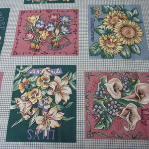 May include: A fabric panel with a patchwork design featuring various flowers and their names. The panel includes a rose, sunflower, crocus, iris, calla lily, and satin lily. Each flower is depicted in a square with a pink or blue background.