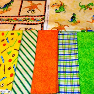 May include: A collection of ten fabric squares, featuring a variety of patterns and colors. The fabrics include a yellow fabric with a pattern of baseball bats, balls, and skateboards, a green and white striped fabric, an orange fabric with a floral pattern, a blue and green plaid fabric, a green fabric with a leafy pattern, and a blue fabric. The fabrics are all approximately 11 inches by 17 inches.