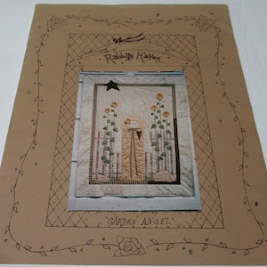 May include: A white ceramic mug with a black handle and the text "But First, Coffee" in a black, bold font. The mug is on a white surface.