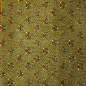 May include: Green fabric with a repeating pattern of stylized trees and red stars. The trees are dark green with small yellow dots, and the stars are a deep red. The background is a muted green.