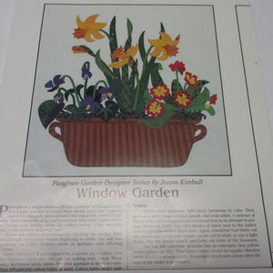 May include: A vintage craft pattern for a "Window Garden" featuring a pot of yellow daffodils, purple violets, and red primroses. The pattern is part of the Foxglove Garden Designer Series by Jeana Kimball.