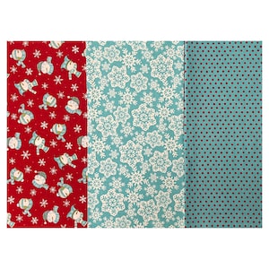 May include: Three fabric swatches with festive patterns. One is red with snowman and snowflake designs, another is teal with white snowflakes, and the third is teal with maroon polka dots. Ideal for Christmas crafts.
