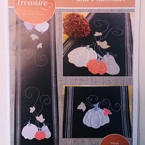 May include: A sewing pattern for a pumpkin runner and placemats. The pattern features a design of pumpkins with vines and leaves. The runner is 14 inches by 50 inches and the placemats are 14 inches by 12 inches. The pattern is made with tea toweling.
