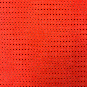 May include: Vibrant red fabric featuring a consistent arrangement of small, black dots. The material has a textured appearance and a non-glossy finish. The design creates a striking visual pattern.