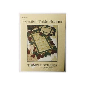May include: A quilting pattern for a Heartfelt Table Runner by Thimbleberries by Lynette Jensen. The pattern features a table runner with a green and brown heart design.