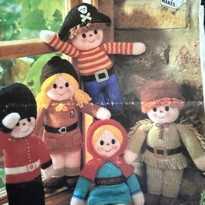 May include: A group of knitted dolls in various costumes, including a pirate and a soldier. The dolls are made with yarn and feature detailed outfits. The image includes the text "GET AHEAD GIFT MAKES".