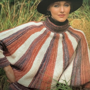May include: A woman wearing a black hat and a striped sweater. The sweater features a pattern of brown, white, and orange stripes radiating from the neckline. The sweater has a high neck and long sleeves. The image is a vintage fashion photograph.