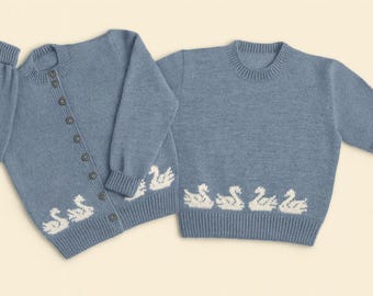 May include: Two pale blue knitted sweaters. One is a button-up cardigan with long sleeves, and the other is a crew neck with short sleeves. Both have a white swan pattern along the bottom hem.