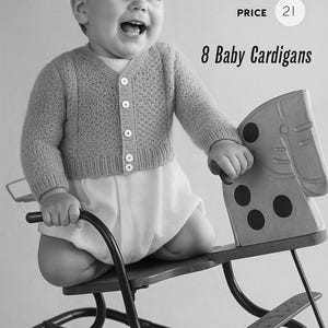 May include: A smiling baby wearing a gray cardigan and white onesie sits on a vintage rocking horse. The image includes text that reads "8 Baby Cardigans" and "No. 106".