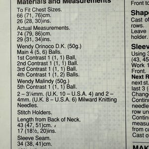 May include: A close-up of a printed page with knitting pattern instructions. The text includes measurements in centimeters and inches, along with details for chest sizes, actual measurements, and yarn requirements. The page also lists needle sizes.