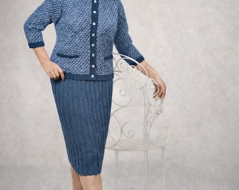 May include: A blue knitted skirt suit in a vintage style. The jacket features a collared neckline, button-down front, and pockets. The knee-length skirt is paired with black heels. The woman is smiling and leaning on a white chair.