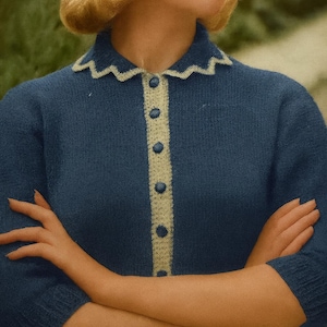 May include: A blue cardigan with a cream-coloured trim and buttons. The cardigan features a scalloped collar and short sleeves. The buttons match the trim. The style is reminiscent of the mid-20th century, with a vintage aesthetic.