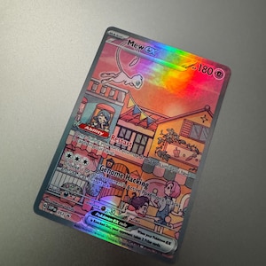 May include: A holographic Mew EX Pokémon trading card. The card features a pink and orange cityscape background with a flying Mew character. The card has text that reads "Restart" and "Genome Hacking".