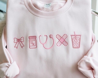 Embroidered Nurse Icon Sweatshirt, Healthcare Shirt, CNA Sweatshirt, Medical Assistant, Nursing Grad Gift, Coquette Nursing Sweatshirt