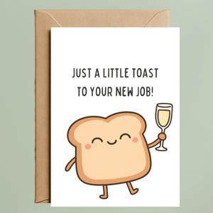 May include: A greeting card with a cartoon illustration of a slice of toast holding a champagne glass. The card reads "JUST A LITTLE TOAST TO YOUR NEW JOB!" The card is inside a brown envelope.